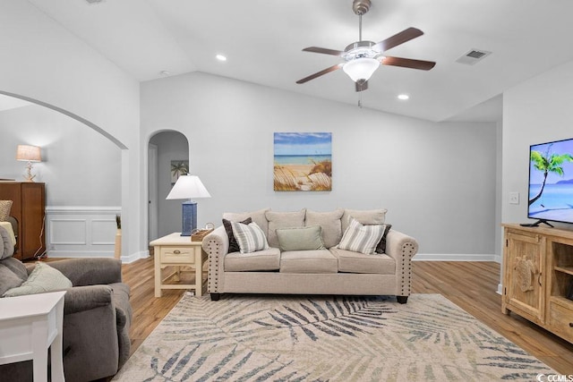 680 Twinflower St, Little River, SC 29566 - living room featuring a ceiling fan, light wood-type flooring, visible vents, arched walkways, and vaulted ceiling