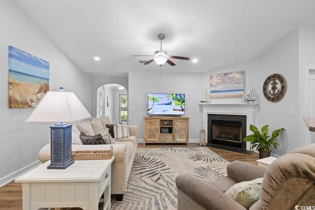 680 Twinflower St, Little River, SC 29566 - living room with wood finished floors, a ceiling fan, a fireplace, arched walkways, and recessed lighting