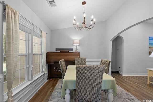 680 Twinflower St, Little River, SC 29566 - dining space with vaulted ceiling, wood finished floors, visible vents, arched walkways, and a chandelier