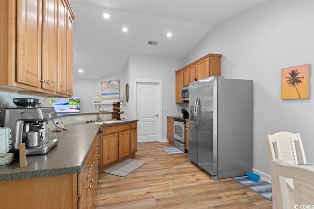 680 Twinflower St, Little River, SC 29566 - kitchen with light wood finished floors, visible vents, a sink, dark countertops, and appliances with stainless steel finishes