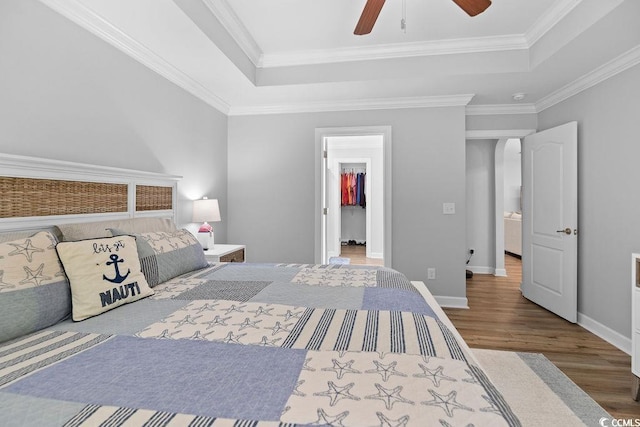 680 Twinflower St, Little River, SC 29566 - bedroom featuring crown molding, a raised ceiling, baseboards, and wood finished floors