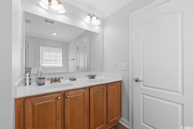 680 Twinflower St, Little River, SC 29566 - bathroom featuring ornamental molding, visible vents, and a sink
