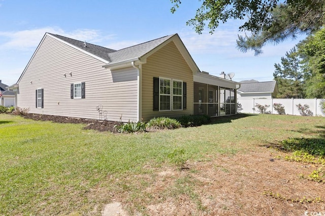 680 Twinflower St, Little River, SC 29566 - view of side of home featuring a yard, fence, and a sunroom