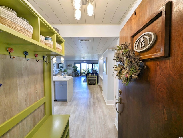 interior space featuring light wood-style floors, wooden ceiling, and visible vents