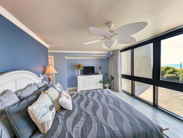 bedroom with ceiling fan, visible vents, ornamental molding, and wood finished floors