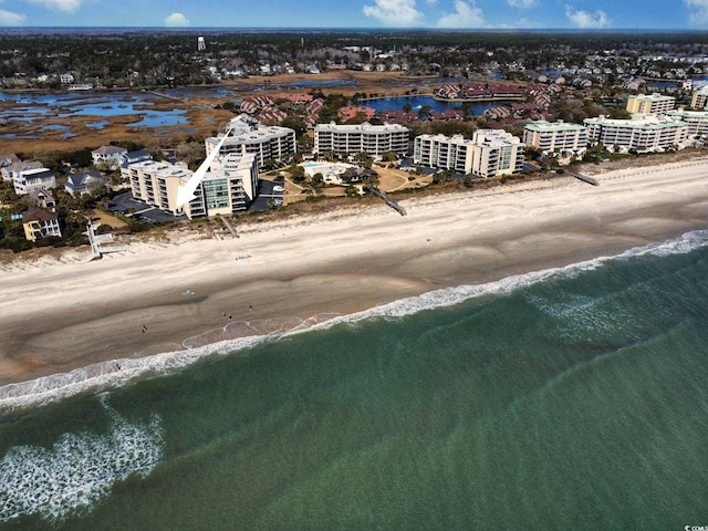 drone / aerial view featuring a view of the beach and a water view