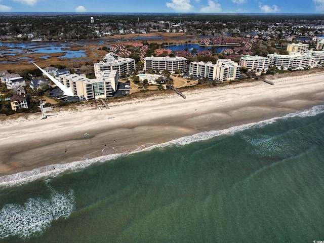 aerial view with a water view and a view of the beach