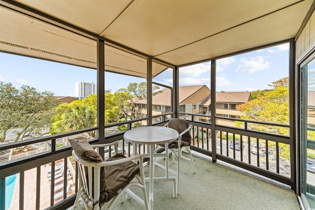 sunroom featuring a residential view