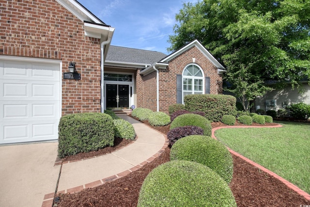 78 Saltwind Loop, Murrells Inlet, SC 29576 - property entrance featuring a lawn, brick siding, and an attached garage