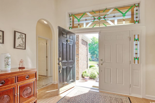 78 Saltwind Loop, Murrells Inlet, SC 29576 - entryway featuring a towering ceiling, arched walkways, baseboards, and light wood-style floors