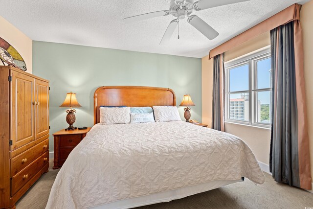 215 77th Ave N Unit 807, Myrtle Beach, SC 29572 - bedroom featuring baseboards, a textured ceiling, light carpet, and ceiling fan