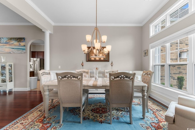 dining space with ornamental molding, wood finished floors, and a wealth of natural light