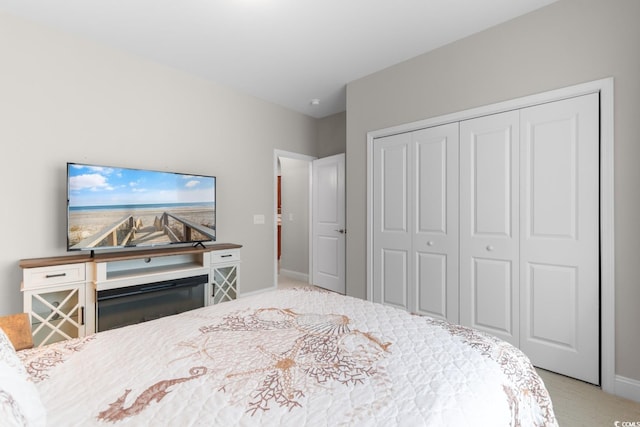 bedroom featuring baseboards, carpet, and a closet