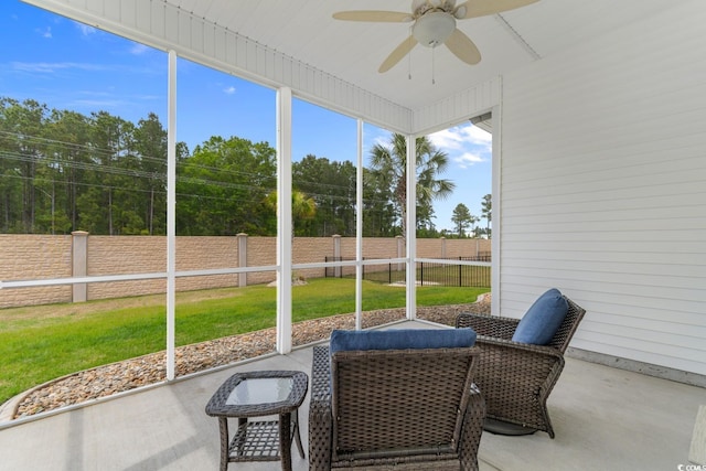 sunroom with a ceiling fan and a wealth of natural light