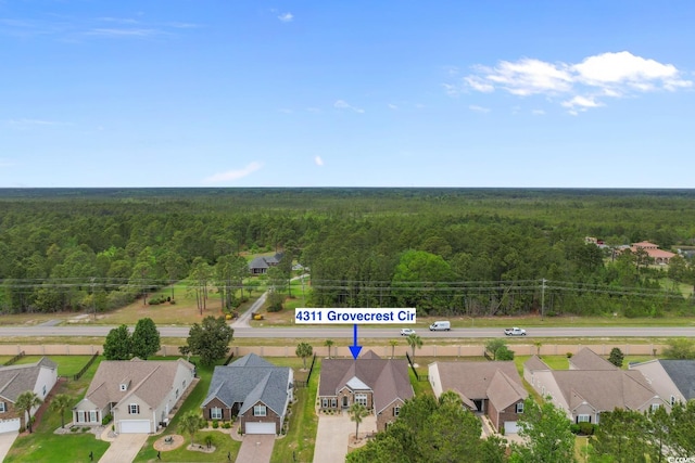 birds eye view of property with a view of trees and a residential view