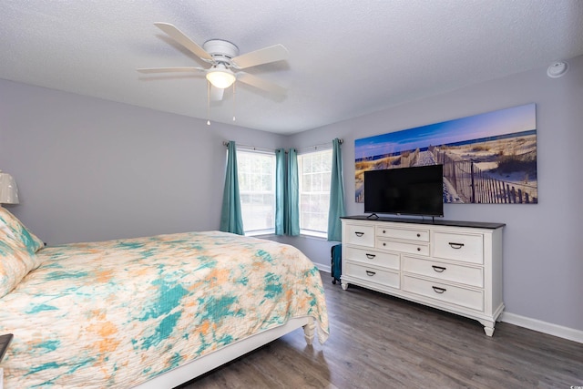 bedroom featuring baseboards, dark wood-style floors, and ceiling fan
