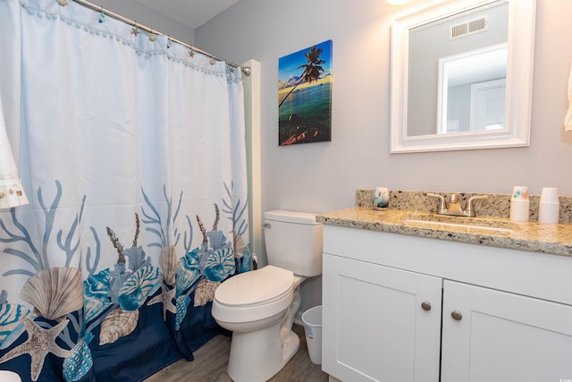 full bathroom with visible vents, wood finished floors, toilet, and vanity