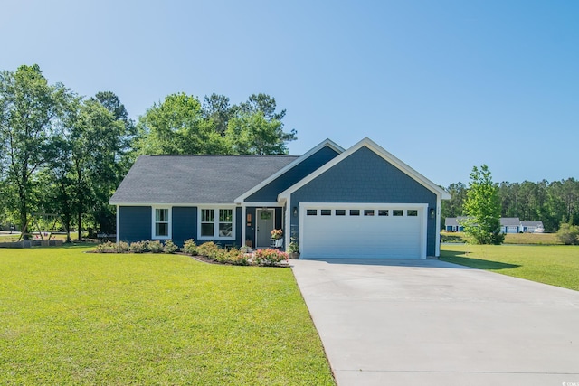 view of front of house featuring concrete driveway, a front yard, and a garage