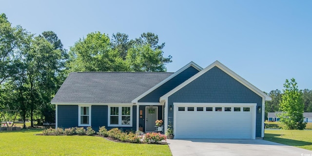 294 Field Loop Rd, Georgetown, SC 29440 - view of front of house with a front lawn, concrete driveway, an attached garage, and roof with shingles