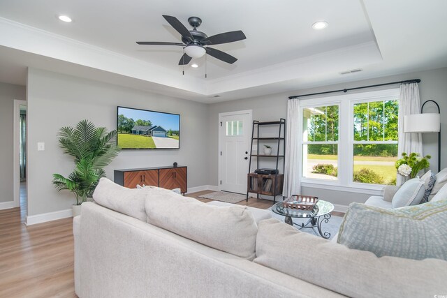 294 Field Loop Rd, Georgetown, SC 29440 - living room featuring a tray ceiling, baseboards, light wood-type flooring, ornamental molding, and recessed lighting