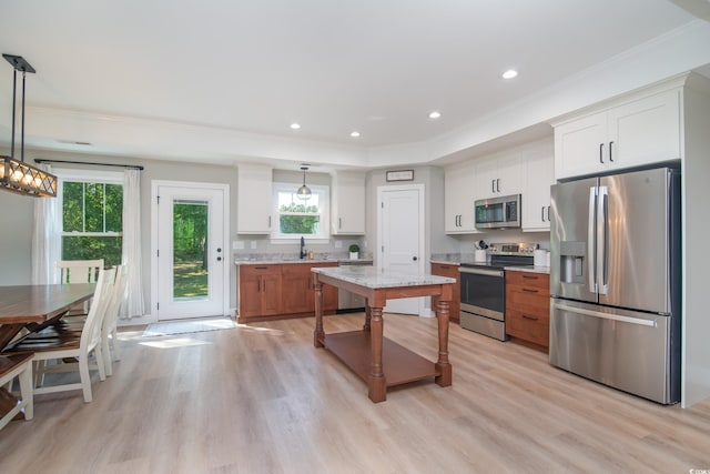 294 Field Loop Rd, Georgetown, SC 29440 - kitchen featuring appliances with stainless steel finishes, crown molding, light wood-type flooring, white cabinets, and recessed lighting