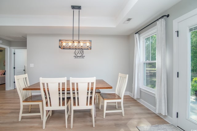 294 Field Loop Rd, Georgetown, SC 29440 - dining room with light wood-style flooring, a raised ceiling, and crown molding