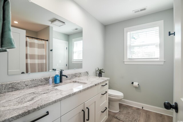 294 Field Loop Rd, Georgetown, SC 29440 - bathroom featuring wood finished floors, vanity, toilet, and baseboards