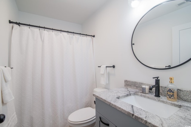 full bath with vanity, toilet, and visible vents
