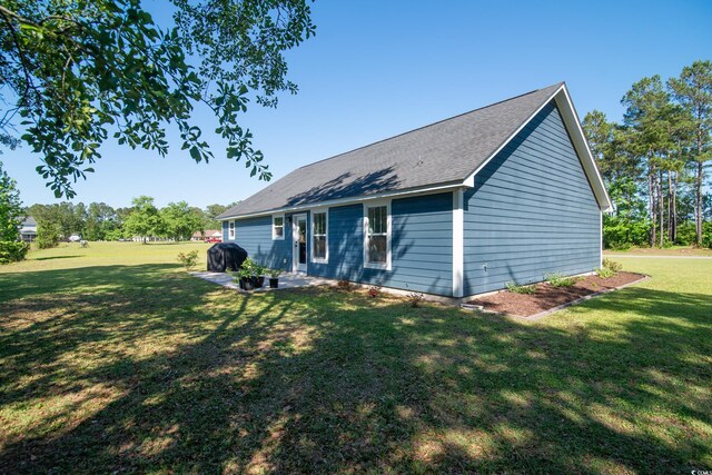 294 Field Loop Rd, Georgetown, SC 29440 - rear view of property featuring a lawn, a patio area, and a shingled roof