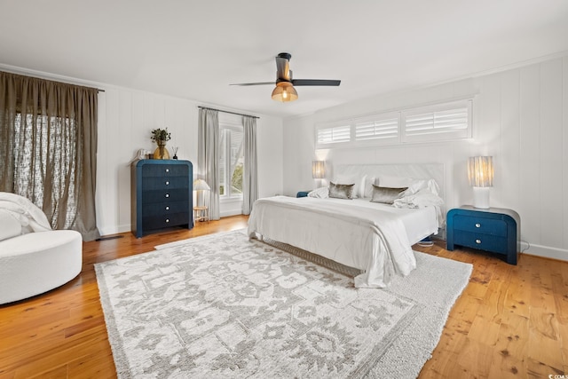 bedroom with a ceiling fan and light wood-style flooring