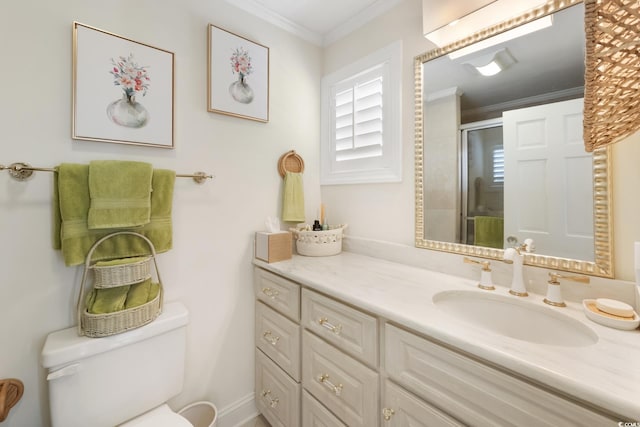 bathroom with vanity, ornamental molding, toilet, and a shower stall
