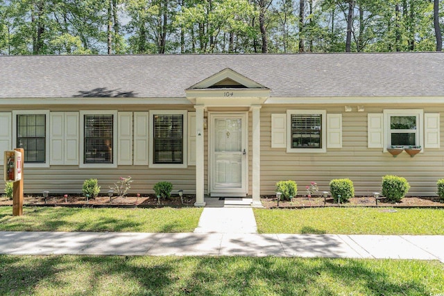 6734 Blue Heron Blvd Unit 104, Myrtle Beach, SC 29588 - ranch-style home with a shingled roof and a front lawn