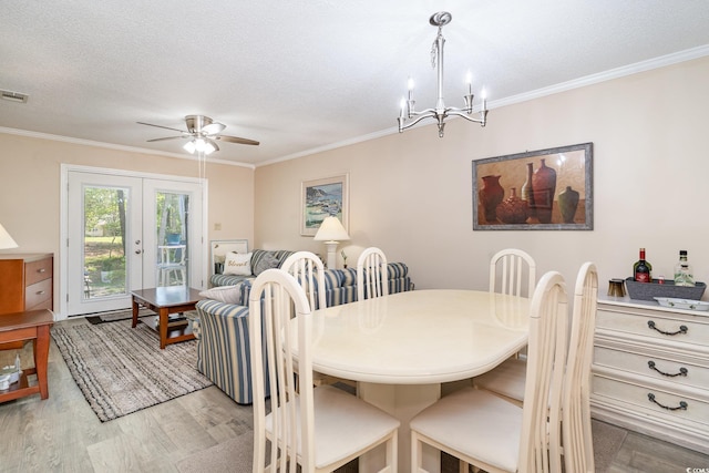 6734 Blue Heron Blvd Unit 104, Myrtle Beach, SC 29588 - dining area with crown molding, light wood-style flooring, and ceiling fan with notable chandelier