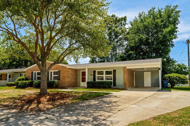 617 Hibiscus Ave Unit 617, Myrtle Beach, SC 29577 - single story home with brick siding, driveway, and a carport