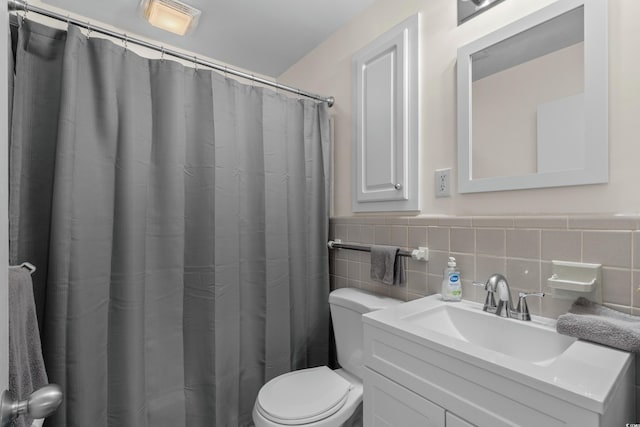 617 Hibiscus Ave Unit 617, Myrtle Beach, SC 29577 - bathroom featuring vanity, wainscoting, toilet, and tile walls