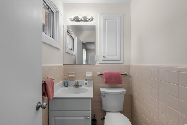 617 Hibiscus Ave Unit 617, Myrtle Beach, SC 29577 - bathroom featuring vanity, a wainscoted wall, toilet, and tile walls