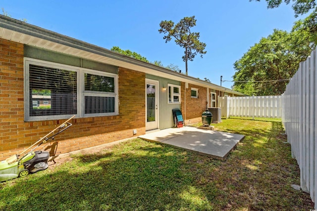 617 Hibiscus Ave Unit 617, Myrtle Beach, SC 29577 - rear view of property with fence, brick siding, cooling unit, a patio area, and a yard