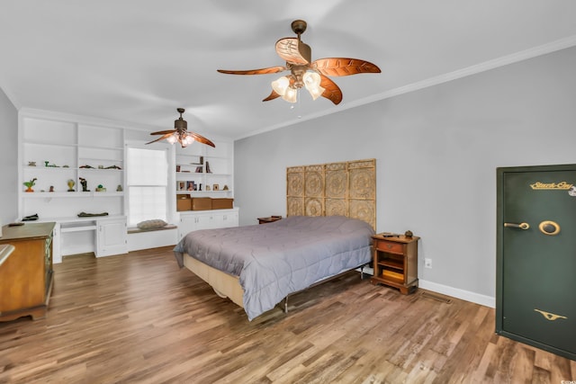 bedroom featuring visible vents, ornamental molding, wood finished floors, baseboards, and ceiling fan