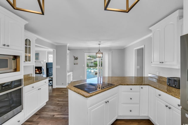 kitchen featuring dark wood-type flooring, a peninsula, white cabinetry, and appliances with stainless steel finishes