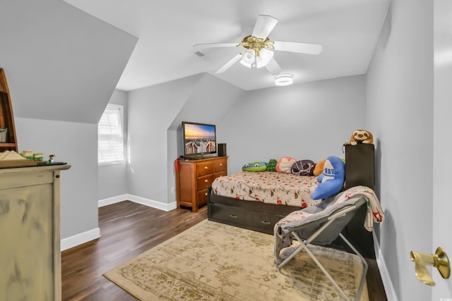 bedroom with baseboards, a ceiling fan, lofted ceiling, and dark wood-type flooring