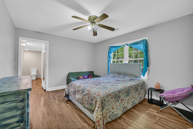 bedroom featuring baseboards, a ceiling fan, and wood finished floors