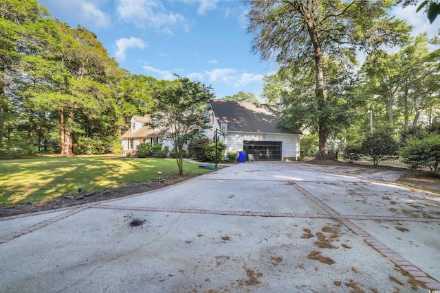 view of front of house with an attached garage, driveway, and a front lawn