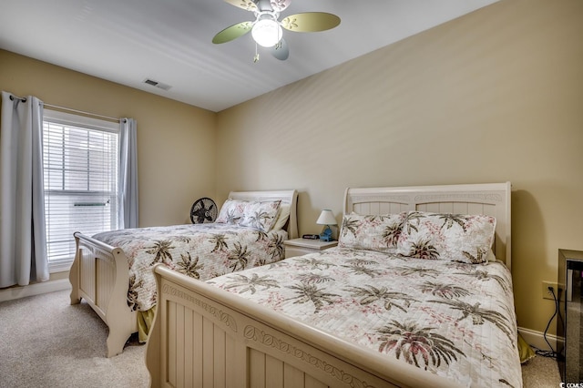 bedroom featuring light colored carpet, ceiling fan, and visible vents