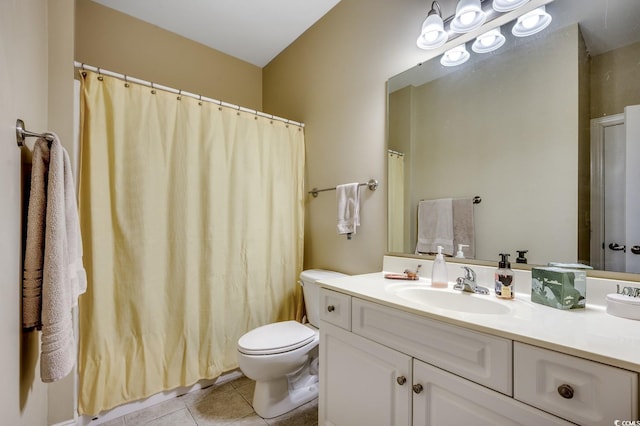 bathroom featuring vanity, tile patterned floors, and toilet