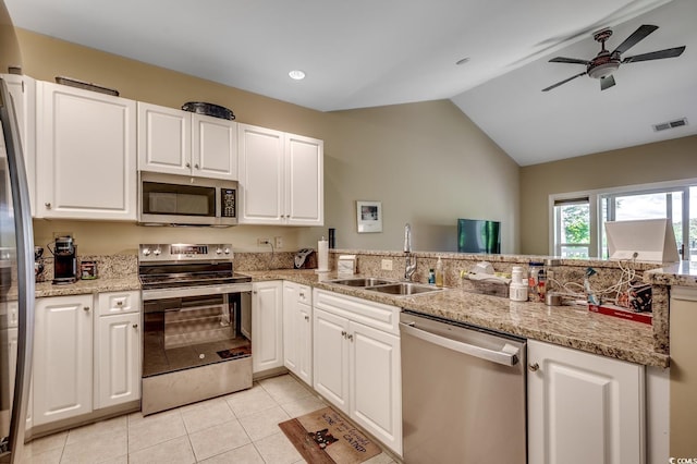 kitchen with visible vents, a ceiling fan, lofted ceiling, a sink, and stainless steel appliances