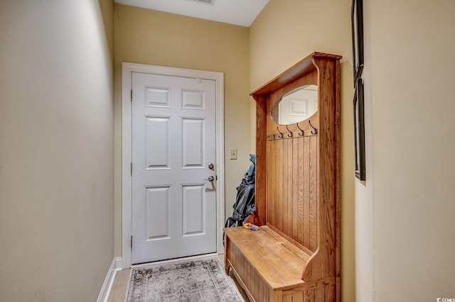 mudroom featuring baseboards and light wood finished floors