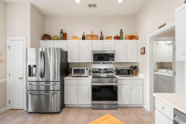 1617 Tradition Club Dr, Pawleys Island, SC 29585 - kitchen with a toaster, light countertops, stainless steel appliances, and visible vents