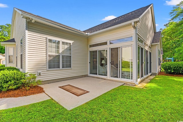 1617 Tradition Club Dr, Pawleys Island, SC 29585 - rear view of property featuring a lawn, a sunroom, a shingled roof, and a patio area