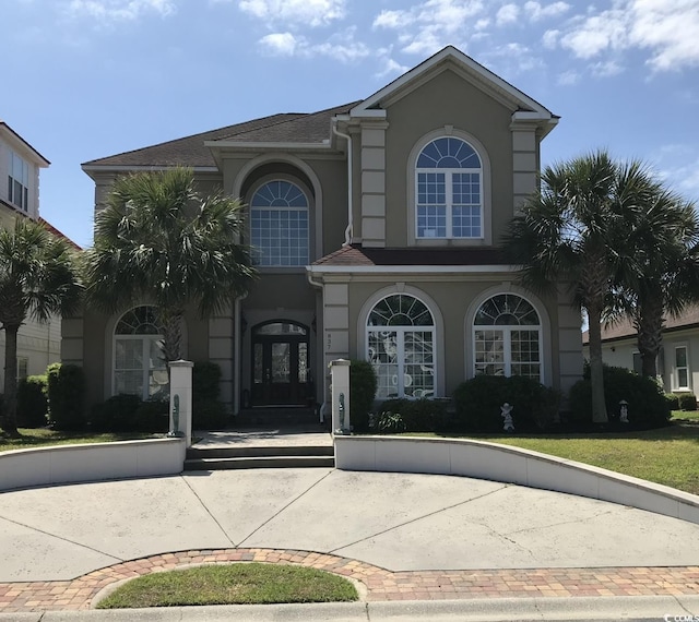 mediterranean / spanish house featuring stucco siding
