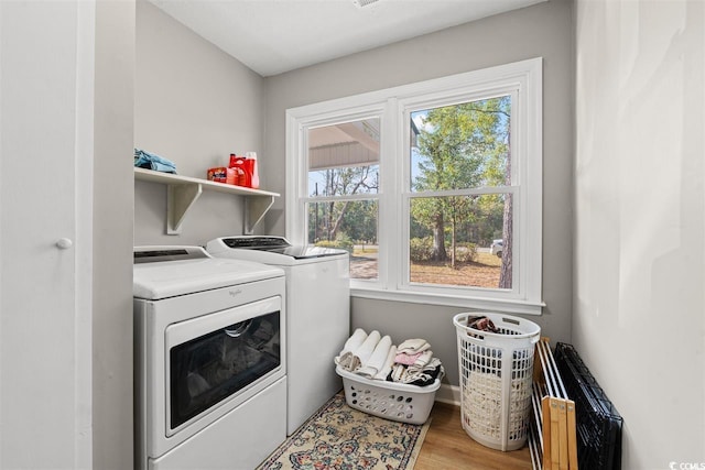 laundry area featuring laundry area, washer and clothes dryer, and wood finished floors